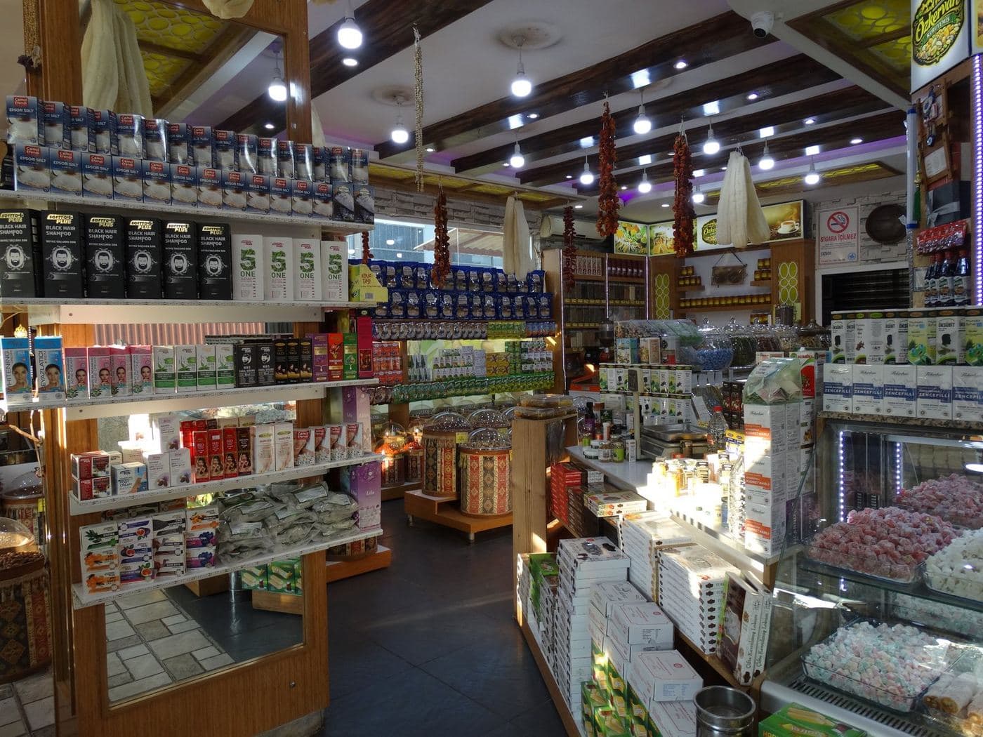 Inside the shop: strings of dried peppers on the ceiling, shelves full on either side